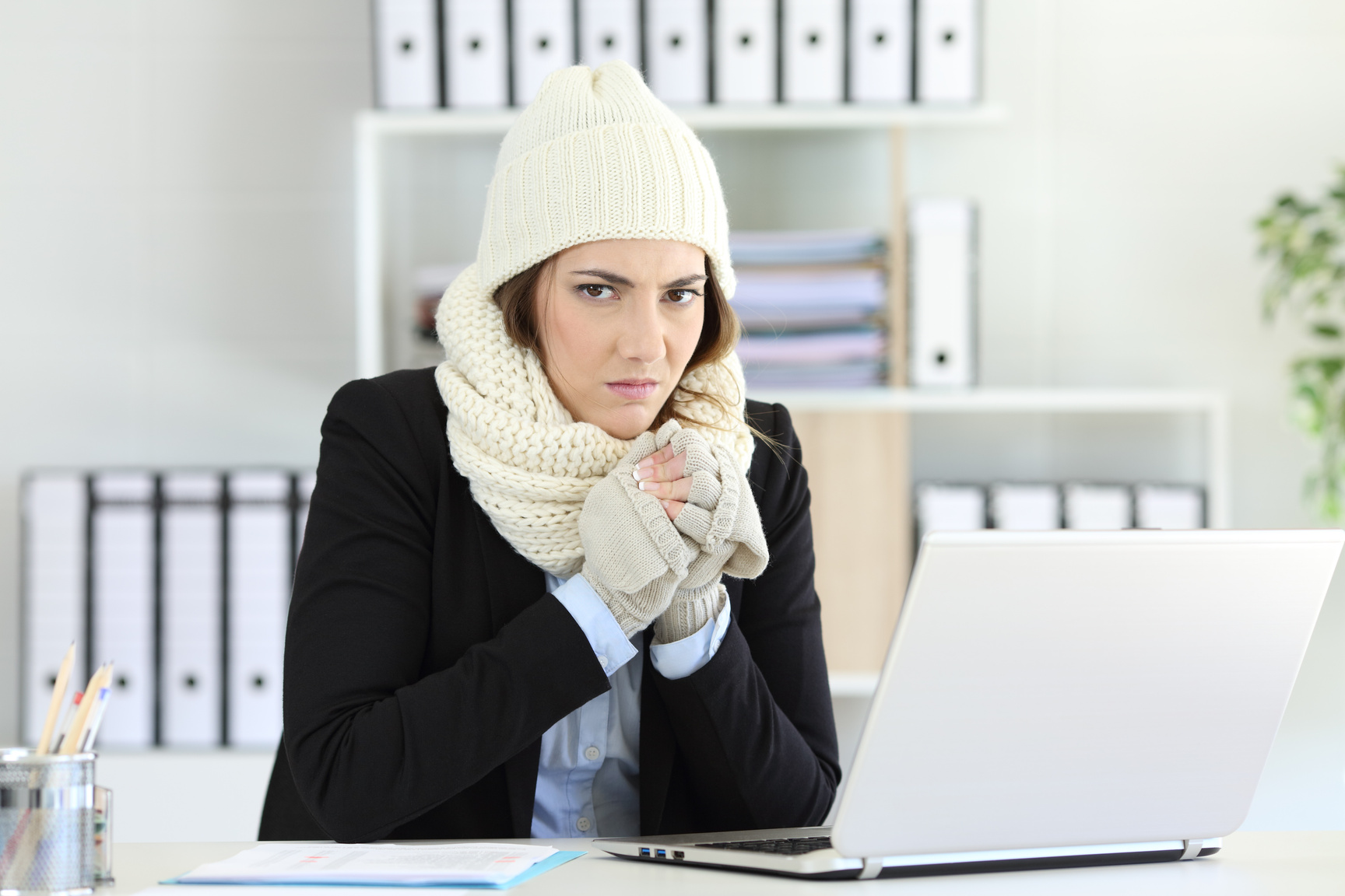 Angry businesswoman having cold at office
