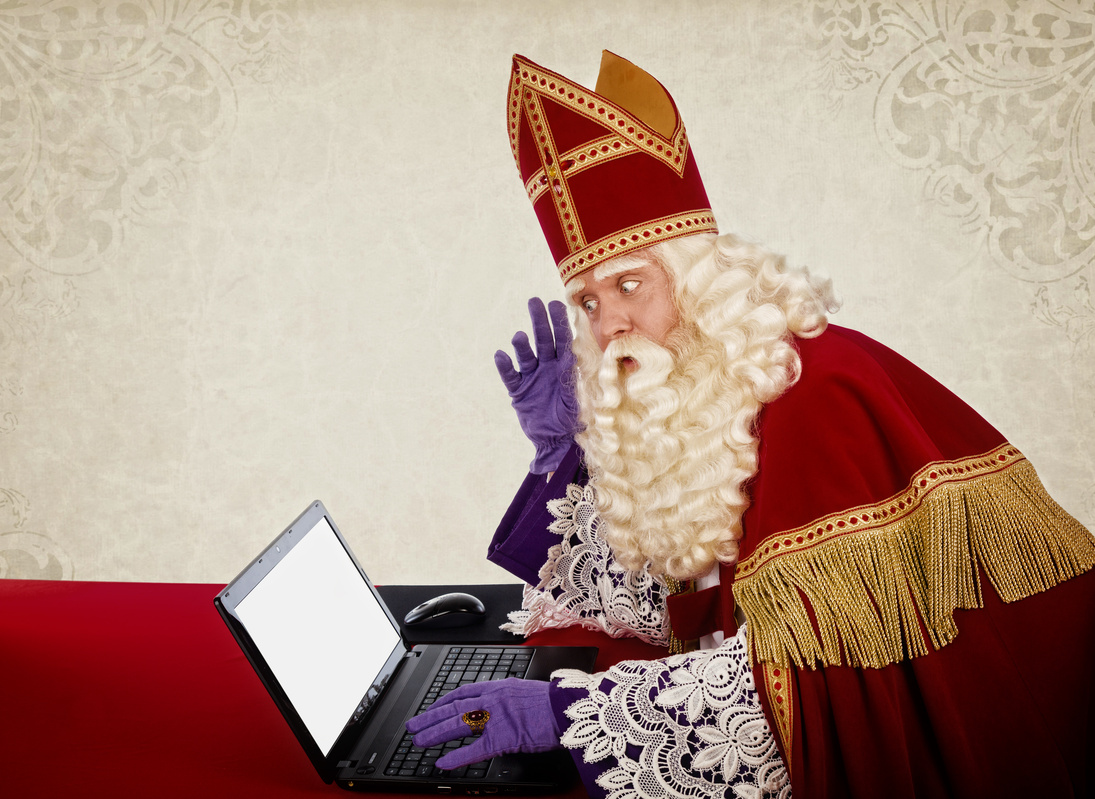 Sinterklaas or Saint Nicholas with laptop